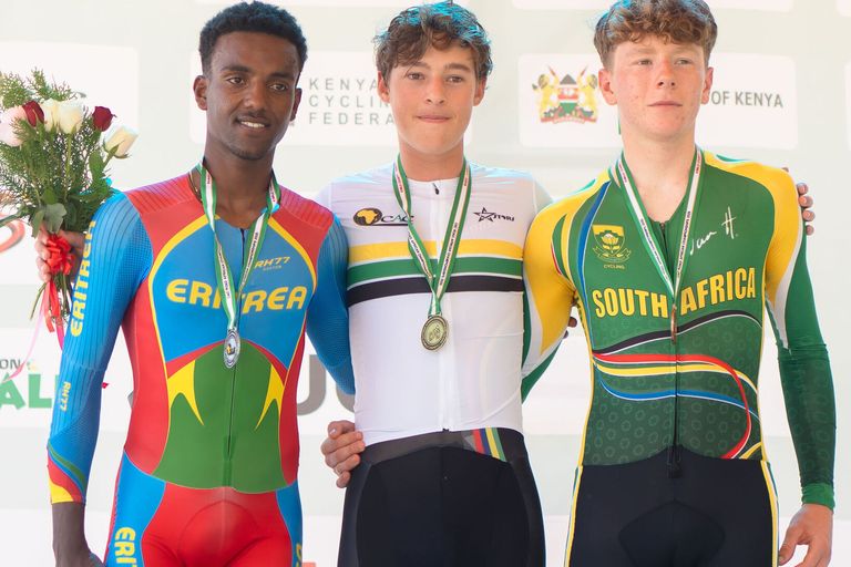 Three junior riders on the podium, medals around their necks