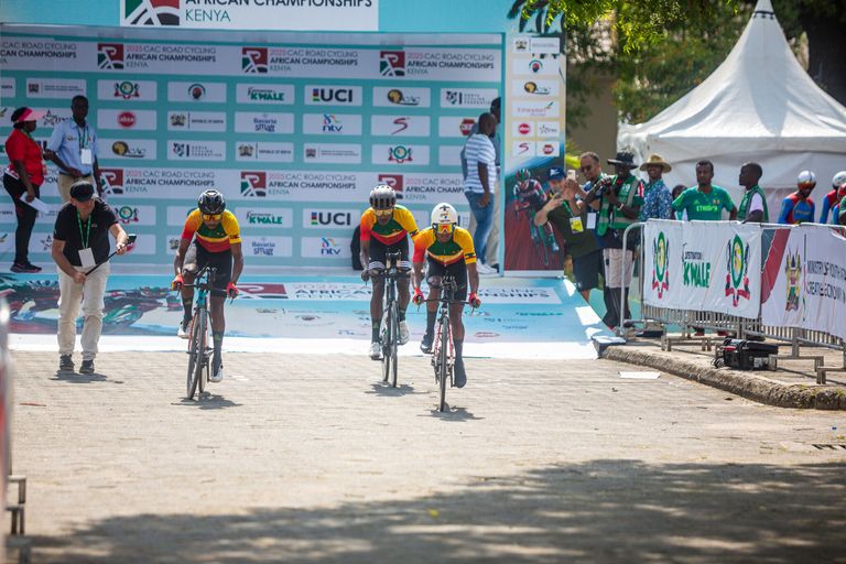 A mixed relay team leaves the start area, under the championship banners