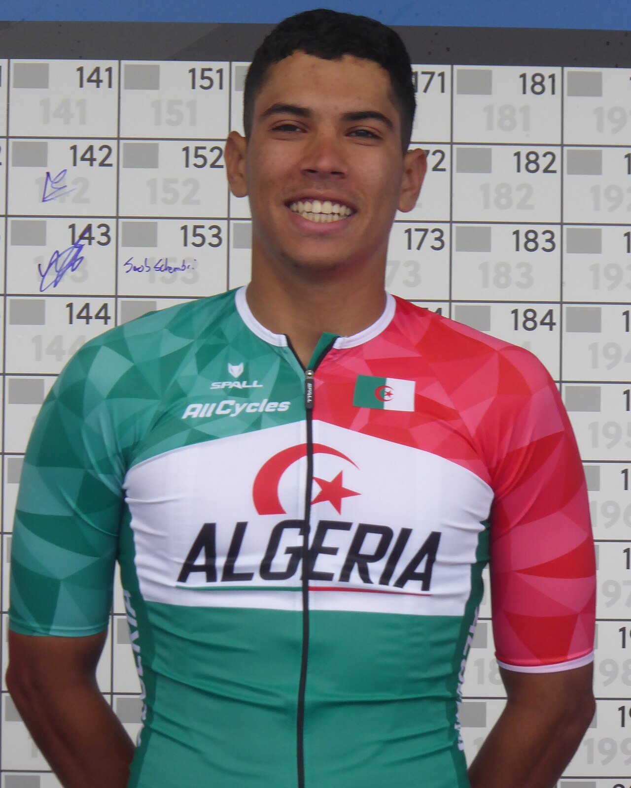 Portrait souriant de Hamza Amari, en maillot de l'équipe d'Algérie