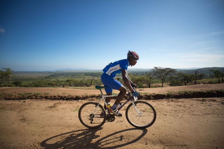 A rider on a dirt track across the Kenyan savannah